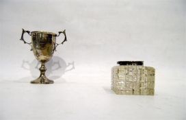 Silver trophy cup with scroll handles, raised on a