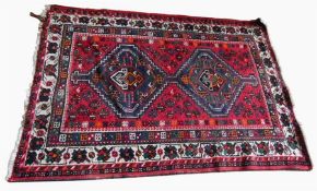 Persian rug, red ground with blue, green, orange a