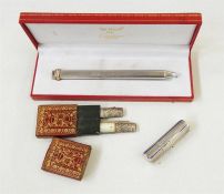 Cartier white metal pencil, cased, a Georgian mother-of-pearl and silver folding knife and fork with