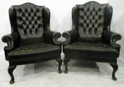 Pair of olive green leather button upholstered wingside chairs on carved cabriole supports, in the