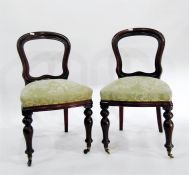 Set of four late 19th century mahogany balloon-back dining chairs with sprung seats, turned front