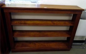 Oak dwarf bookcase with reeded edged top and having three open shelves, channelled uprights,