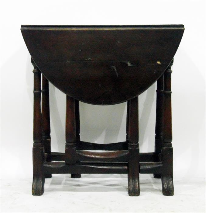 Late 18th century oak oval fall-flap gateleg table having Spanish style feet, 68cm wide