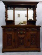 Victorian carved oak sideboard with mirrored back, three drawers above three cupboards, on bun feet,