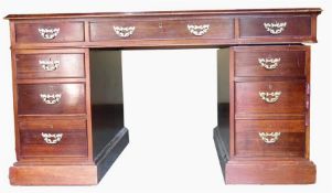 Mahogany kneehole pedestal desk having an arrangement of nine drawers, each with brass swan-neck