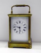 Brass carriage clock in corniche case, with striking movement, 18cm high over the handle
