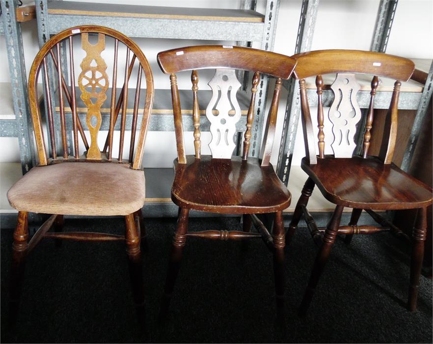Pair of spindleback chairs with pierced splat and solid seats, on turned legs and a wheelback