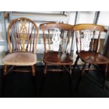 Pair of spindleback chairs with pierced splat and solid seats, on turned legs and a wheelback