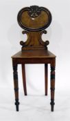 19th century mahogany hall chair with carved and C-scrolled back, solid seat, on turned supports and