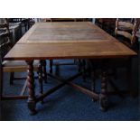 Oak draw-leaf dining table on turned spiral legs united by cross-stretcher, length extended 152cm