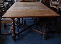 Oak draw-leaf dining table on turned spiral legs united by cross-stretcher, length extended 152cm