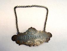 Victorian silver brandy label, Birmingham 1856, by George Unite, cartouche-shaped and scroll