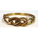 9ct gold bangle with wavy decoration, makers 'M&J', marked 9ct, 12g