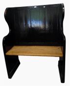 Old black painted panel back settle with downswept arms, on stile supports, width 92cm