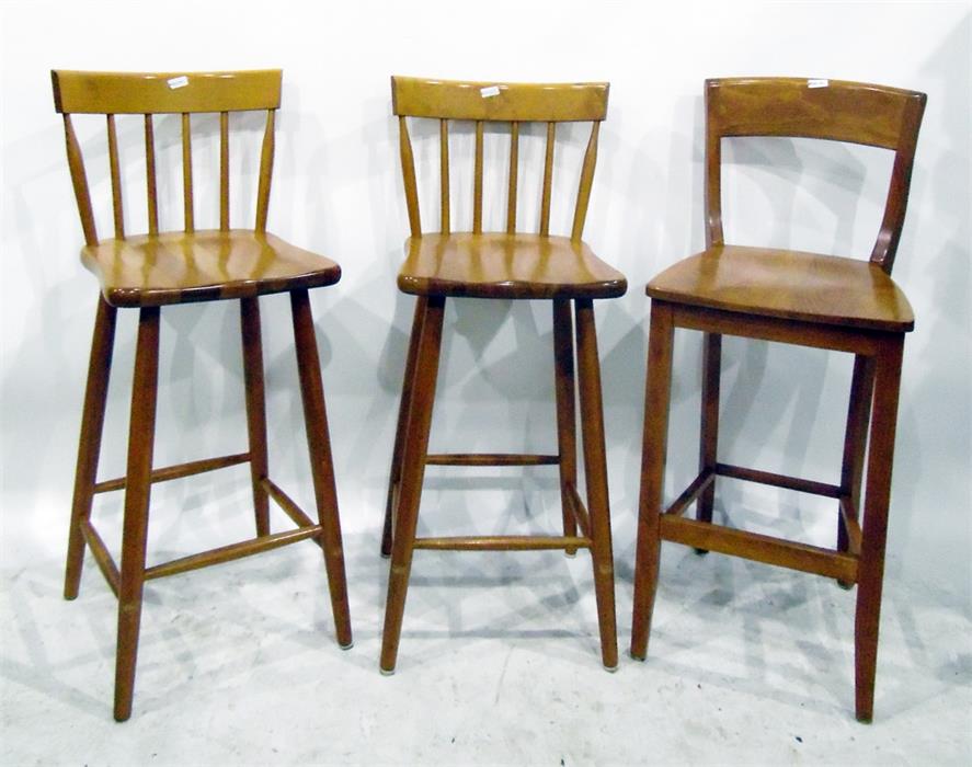 Three beech spindleback bar chairs with solid seats, on turned legs and another pair of bar