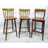Three beech spindleback bar chairs with solid seats, on turned legs and another pair of bar