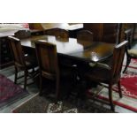 Oak extending dining table on bulbous supports united by central stretcher with a set of six