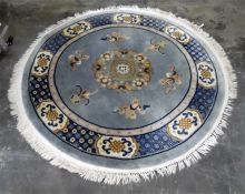 Chinese circular wool rug, blue ground with beige and pink decoration, 177cm diameter