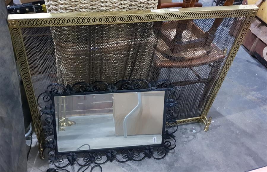 Brass-coloured metal spark guard with draw back wire curtains and a mirror with wrought iron