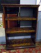 Walnut free-standing bookshelf of four shelves, on plinth base, 56.5cm wide