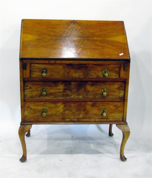 Queen Anne style walnut bureau, the fall front enclosing pigeonholes and small drawer, three long