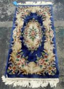 Chinese blue and cream wool rug, 179cm x 78cm