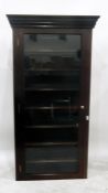Mahogany bookcase with dentil cornice, the glazed panel door enclosing seven shelves (