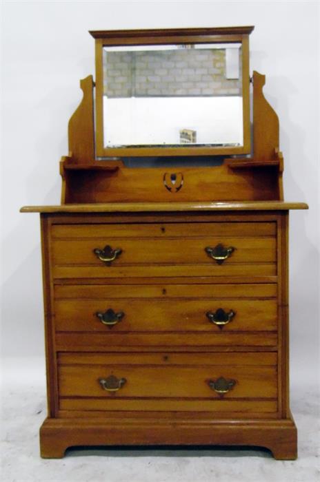 Edwardian satin walnut dressing chest having pivoted bevelled plate mirror over three drawers,