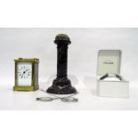 19th century brass carriage clock with enamel dial, a polished stone column (possibly wig stand),
