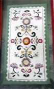 Modern wool rug, white ground with green border and floral decoration, 152cm x 80cm
