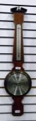 Modern barometer made by Comitti of London, with temperature, within a veneered frame with a