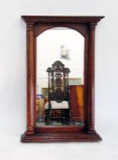 Walnut-framed wall mirror with turned column supports, the arched mirror plate 75cm x 36cm