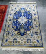 Persian style wool rug in beige, blue and green, with lozenge centre, 193cm x 115cm