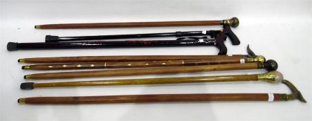 Quantity of walking sticks inlaid with brass, with brass handles, etc (8)