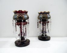 Pair of Victorian cranberry glass lustres, floral decorated with clear glass lustre drops, 34cm high