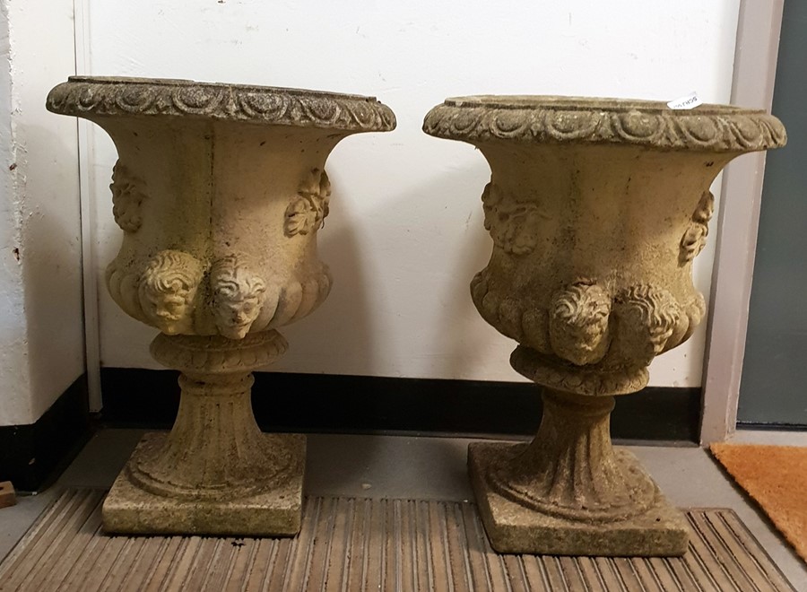 Set of three composite stone garden urns, the egg