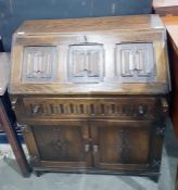 Reproduction oak Jacobean style bureau with linenf