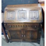 Reproduction oak Jacobean style bureau with linenf