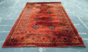 Persian style wool rug, red ground with striped bo