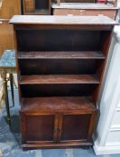 Oak shelving unit with three shelves above two cup