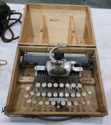 Blick aluminium featherweight typewriter within an