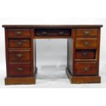 Edwardian walnut kneehole pedestal desk having an