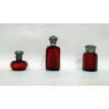Three 19th Century ruby glass dressing table bottl
