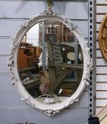 Oval wall mirror in a white painted leaf moulded f