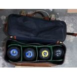Four bowling balls within a fitted canvas and plas