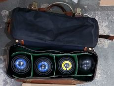 Four bowling balls within a fitted canvas and plas