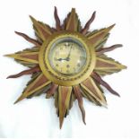 Sunburst design wall clock within carved wooden fr