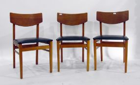 Three laminated teak-finish dining chairs with bla