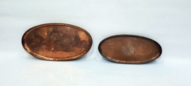 Two oval copper trays, graduated sizes, one embossed with a bunch of flowers, both with gadrooned r