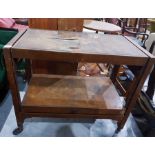 Walnut veneered two-tier tea trolley, an open book